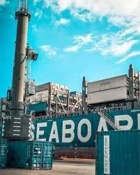 Stacked shipping containers with Seaboard branding at a terminal.